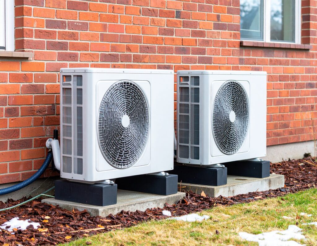 Air source heat pumps installed outside a UK home as part of a low-carbon heating upgrade supported by the Boiler Upgrade Scheme.