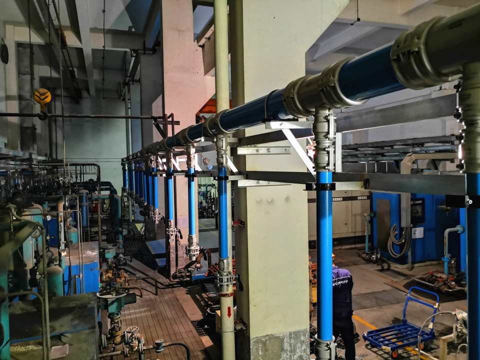 Interior view of a commercial purge system facility showcasing industrial piping, valves, and control systems for air purification.