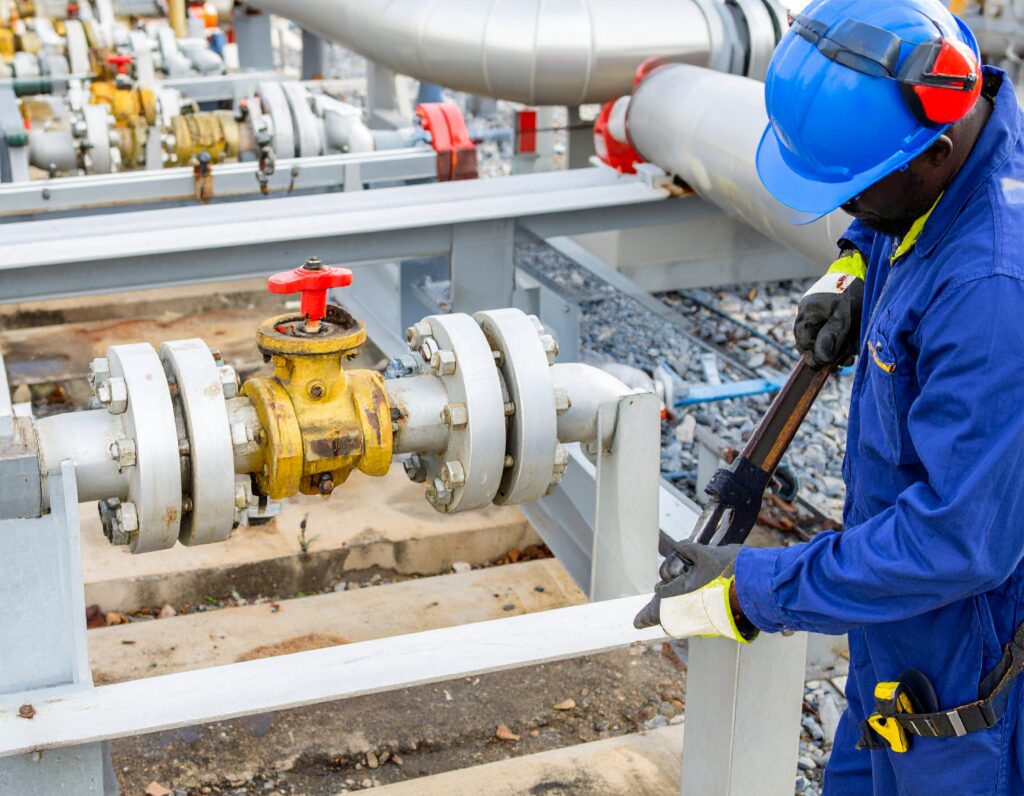 Engineer performing commercial gas purging repair on industrial pipeline system.