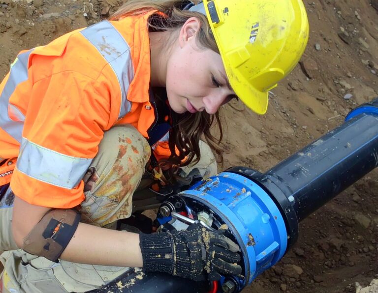 Engineer conducting Post-Repair Pressure Testing on a pipeline connection at a construction site